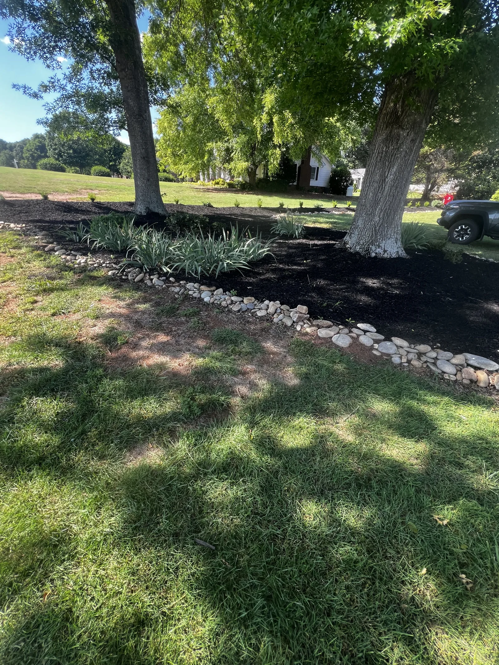Landscape bed with rock edging and mulch